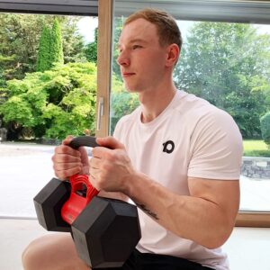 man holding adjustable kettlebell