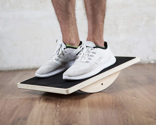 model on wooden balance board