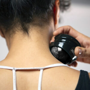 Woman massaging her neck with a massage ball