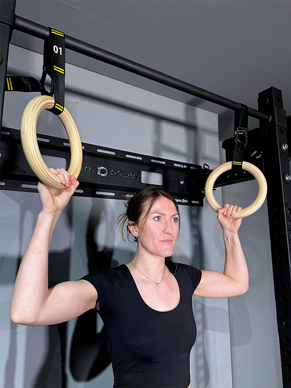 woman exercising with gymnastic rings