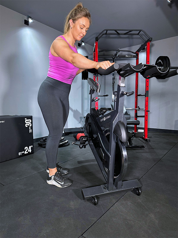 Woman exercising on commercial spin bike