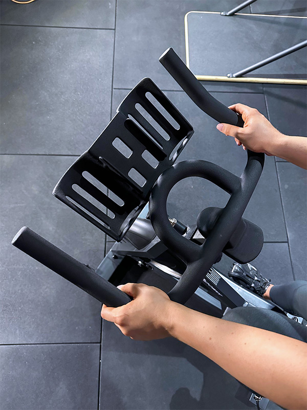 woman holding spin bike handles