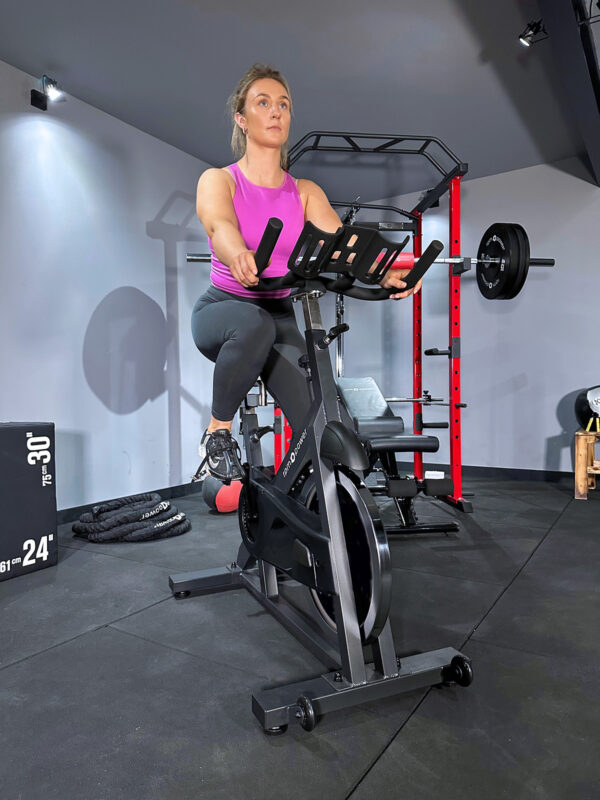 Woman exercising on commercial spin bike