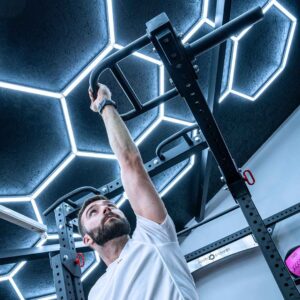 Man with Jammer Arms Pair Exercising on Power Rack