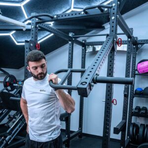 Man with Jammer Arms Pair Exercising on Power Rack