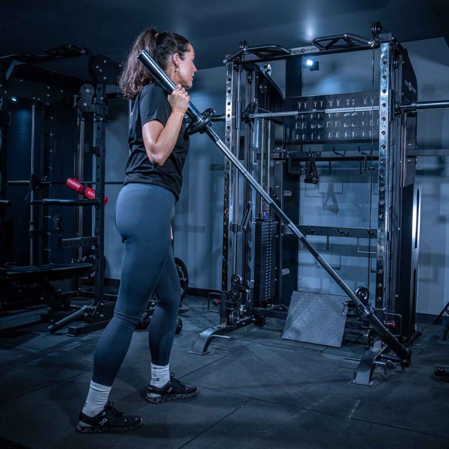 Woman using Multigym with Smith Bar, Weight Stack and Pull Up bar