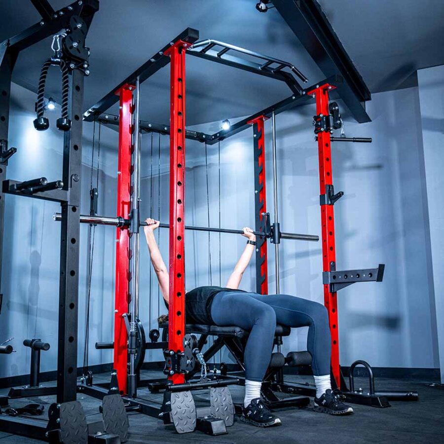 Woman using Power Rack with Smith Bar