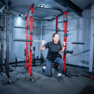 Woman using Power Rack with Smith Bar