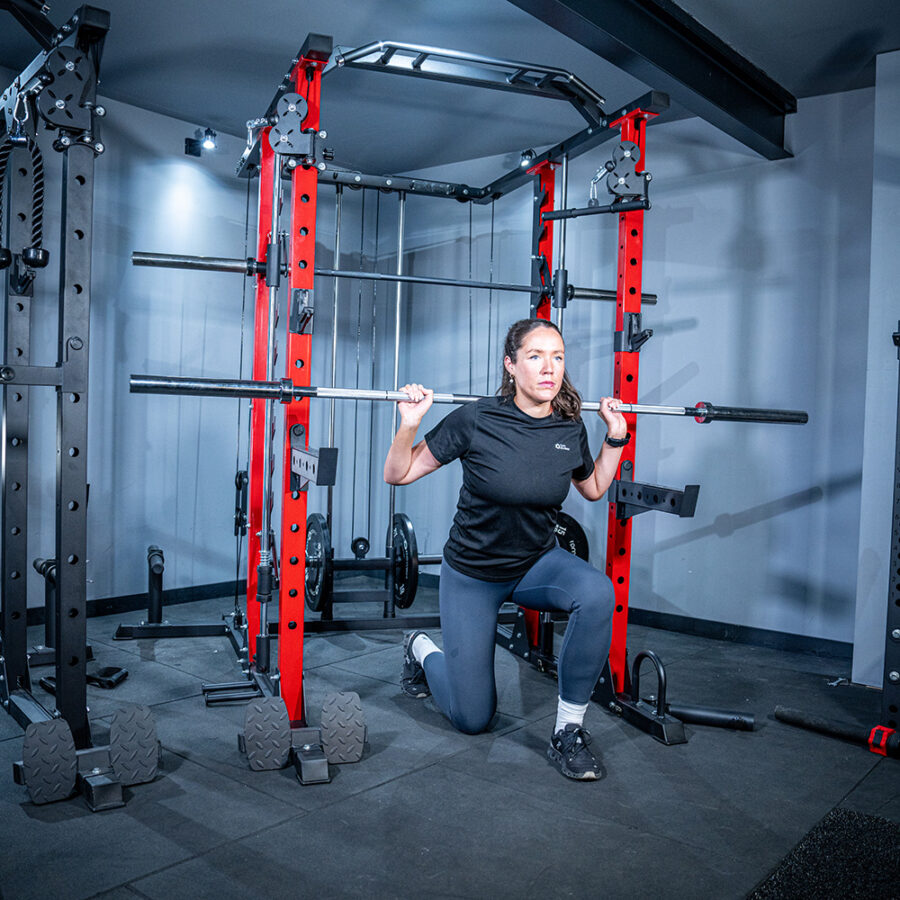 Woman using Power Rack with Smith Bar