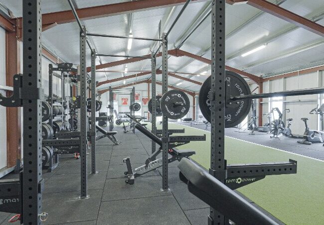 Wall-mounted bag rigs and a bench in Cashel RFC
